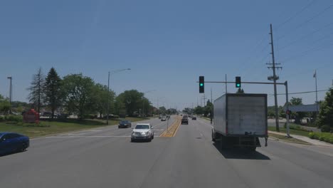Moving-trucks-and-cars-at-traffic-light-in-Glenwood