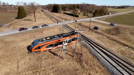 Drone-shot-of-Elron-train-wreck-next-to-railway-and-same-time-another-Elron-train-drives-next-to-it