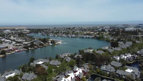Stunning-Areal-Shot-Over-Blue-Lagoon,-Holiday-Destination,-Villas-On-Both-Sides,-San-Mateo