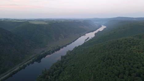 aerial-footage-of-the-river-Moselle-and-its-beautiful-green-forested-hills-near-cochem-at-the-Cochem-Zell-district-in-Rhineland-Palatinate-in-Germany