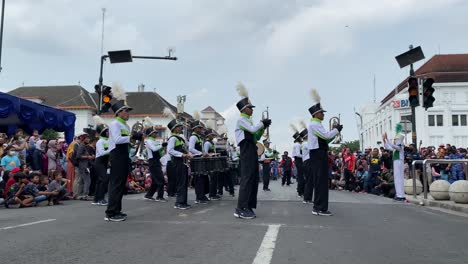 Marching-band-parade,-choreographing-among-enthusiastic-crowds-to-see-them-perform-energetically