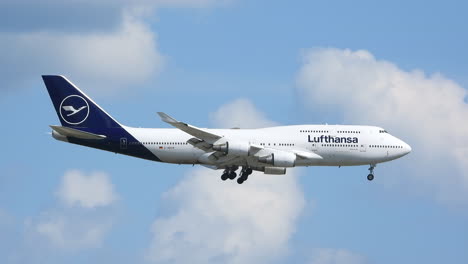 Airplane-landing-scenery-against-blue-sky-with-clouds