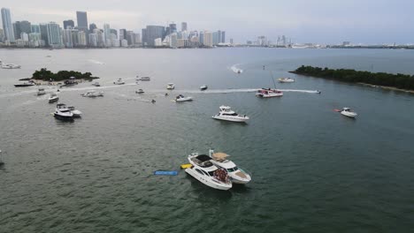 Group-of-Spring-Break-Vacationers-on-Yacht-Boat-on-Coast-of-Miami,-Florida---Aerial-Pullback-Reveal
