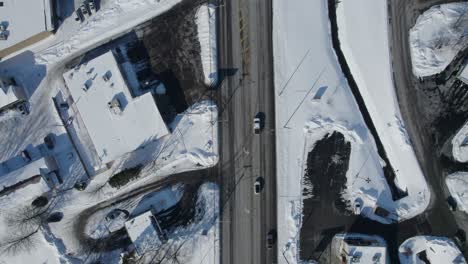 Drone-view-of-country-roads-and-houses-in-winter-season-with-fresh-snow