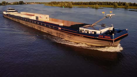 Aerial-Off-Starboard-Side-Of-FPS-Waal-Inland-Cargo-Vessel-Along-Oude-Maas-With-During-Golden-Hour