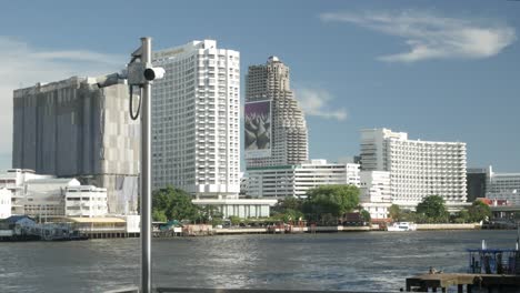view-of-Chao-phraya-river-in-bangkok-while-in-boat-with-bangkok-higrise-building-on-the-river-bank