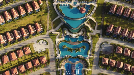 Aerial-birdseye-flying-over-Centara-Mirage-Resort-pools-revealing-constructions