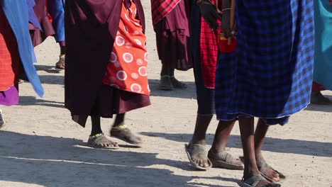 A-clip-of-a-group-of-Maasai-men-and-woman-dancing,-celebrating-and-greeting-during-migration-season-in-the-Ngorongoro-crater-Tanzania