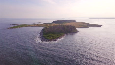 Aerial-shot-flying-over-the-deep-blue-Atlantic-ocean-to-Richmond-Island-off-the-Maine-coast