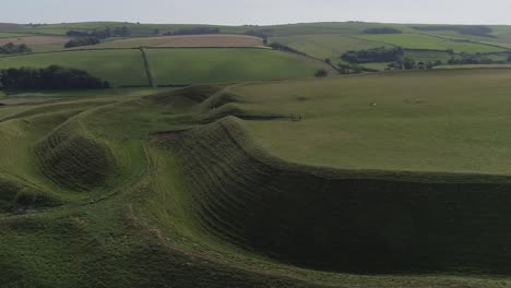 Aerial-tracking-around-the-eastern-gate-of-the-iron-age-hill-fort,-Maiden-Castle