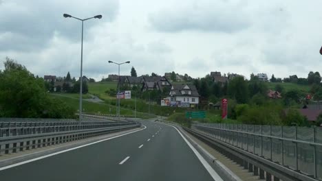 Driving-on-the-road,-into-the-village-of-Zakopane-in-Poland