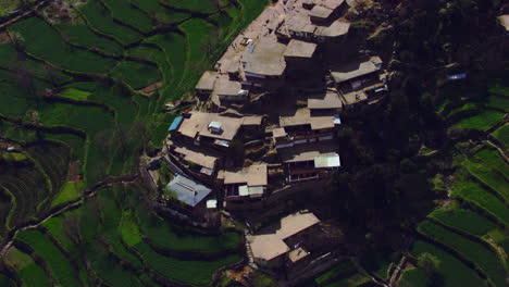A-picturesque-village-with-beautiful-scenes-of-mountains-aerial-view,-as-well-as-charmingly-crafted-greenery