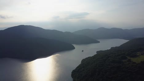 Aerial-view-of-sun-reflections-over-lake-ashi-with-ship