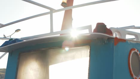 Golden-hour-sunlight-through-cabin-window-of-traditional-Greek-fishing-boat-slow-motion