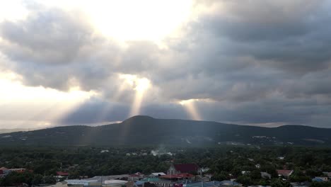 Sunbeams-break-through-clouds-rolling-over-Kingston,-Jamaica