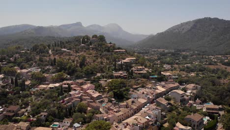 AERIAL:-Overview-shot-of-beautiful-village-on-the-hills-in-mallorca