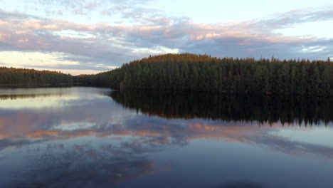 Stunning-drone-footage-of-a-serene-forest-lake-in-the-borealis-wilderness