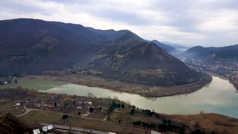Slow-pan-of-Aragvi-river-and-Mtkvari-river-merging-together-near-the-Mtskheta-city-in-the-morning-during-December-in-Georgia