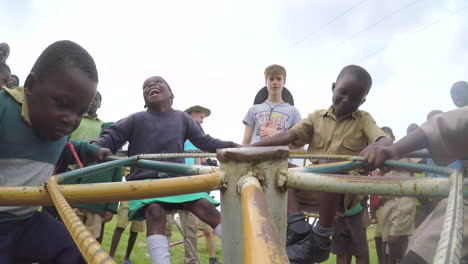 African-Children-Spinning-Around-on-a-Playground-Roundabout,-GoPro-Point-of-View-Shot-in-Slow-Motion