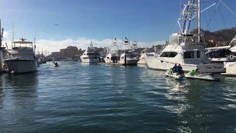Jet-Skis-Being-Towed-Through-the-Marina-of-Cabo-San-Lucas,-Mexico