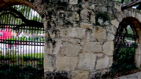 Stone-Walls-line-The-Alamo-grounds-where-visitors-can-learn-of-the-deeds-of-Davy-Crockett-and-William-Travis-during-the-13-days-of-the-siege-and-battle-for-Independence-4K30fps-Seg-2-of-2-Slow-Motion