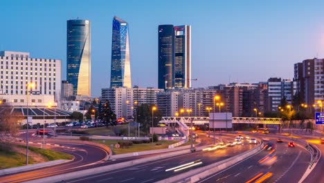 Madrid-four-towers-bussines-area-at-sunset-with-highway-in-the-foreground
