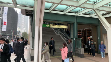 People-and-office-worker-climbing-and-descending-mechanical-stair-of-East-entrance-exit-of-Ebisu-Station