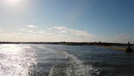 Final-section-of-Ferry-to-IJmuiden-leaving-Newcastle-on-the-Tyne-River,-England-on-a-very-calm-day-with-blue-skies
