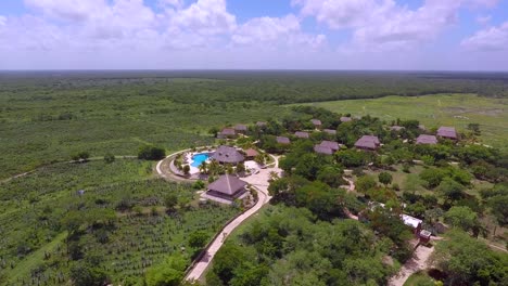 aerial-view-of-a-pool-and-hotel-cabins-in-an-old-henequen-hacienda-in-the-state-of-Yucatan,-Mexico