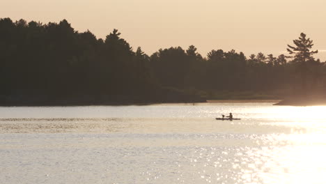 Kayakers-out-for-an-evening-paddle-on-the-lake-during-sunset