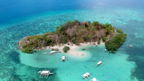 Aerial-wide-shot-of-CYC-beach-on-CYC-Island,-Coron-town,-Philippines