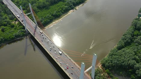 Aerial-or-top-view-from-drone-of-concrete-bridge-with-asphalt-road-or-highway-over-big-river-with-city-car-traffic,-urban-transportation,-toned
