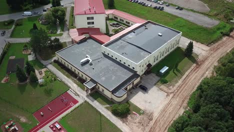Aerial-orbit-flying-over-primary-school-in-Smiltene,-Latvia