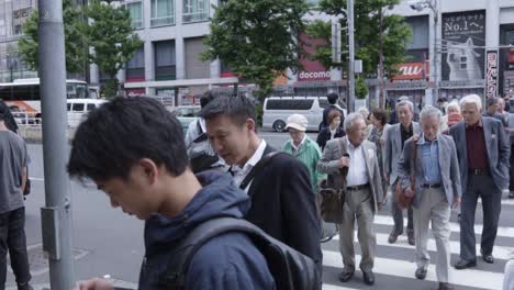 Crossroads-In-Tokyo,-Japan-Are-Sending-People-In-All-Directions-In-The-District--Close-Up-Shot