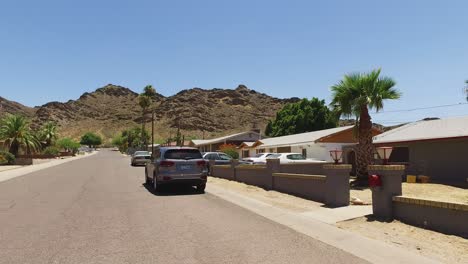 Dolly-down-city-roadway-toward-the-Phoenix-Mountain-preserve-in-North-Phoenix,-Sunnyslope,-Phoenix,-Arizona-Concept:-unique,-cityscape,-transportation