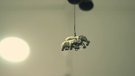 Small-metal-elephant-hanging-from-the-rooftop