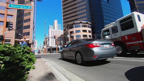 Low-angle-of-a-crowd-of-pedestrians-crossing-Central-Ave-at-Washington-Street-at-the-crosswalk,-Phoenix,-Arizona