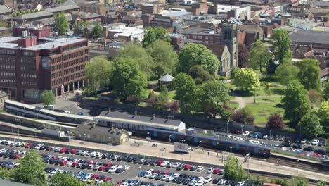Static-aerial-view-of-commuters-boarding-a-train-in-Maidstone-East-train-station-in-Maidstone,-Kent,-UK