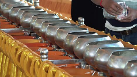 Man-Puts-Rice-in-the-Monk-Pots-at-the-Buddhist-Temple