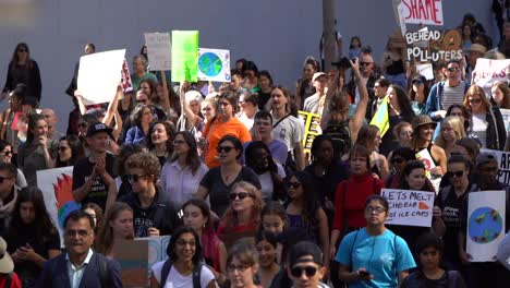 Crowds-walking-in-street-protesting-global-climate-change-march-slow-motion