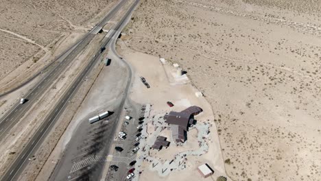 High-altitude-aerial-over-the-rest-stop-on-southbound-interstate-15-in-Nevada,-near-the-Mojave-desert