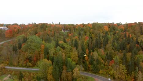 Aerial-View-of-the-Sigulda-Bridge-and-Cable-Car-Over-Gauja-River-During-Golden-Autumn-Season-in-Latvia