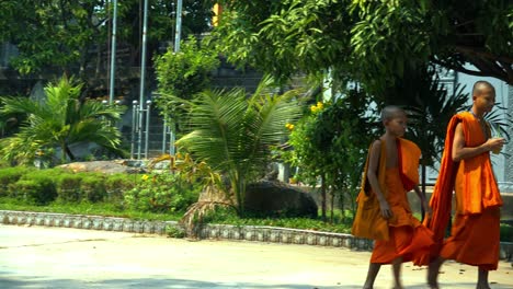 Pan-Shot-of-Young-Monks-Walking-Barefoot-in-Pagoda