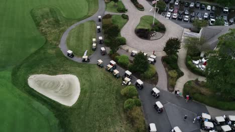 Drone-video-following-a-long-row-of-golf-carts-driving-along-a-concrete-path-before-a-golf-tournament-in-Maryland