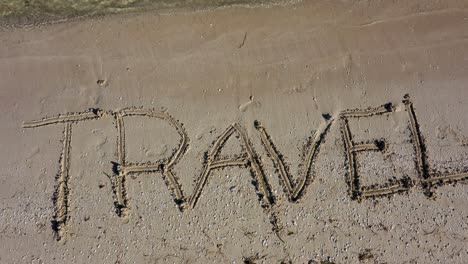 Static-shot-of-TRAVEL-written-in-the-sand-at-an-angle