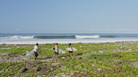 Beautiful-empty-beach,-surfers-exploring-perfect-secluded-wave-paradise