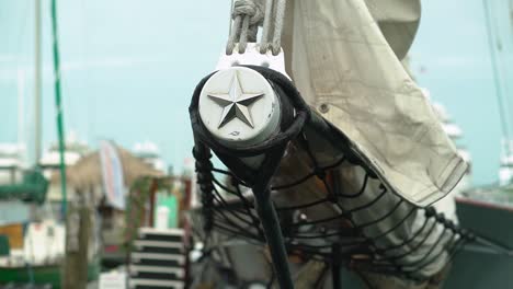 Close-Up-Tracking-Shot-of-Bowsprit-on-Front-of-a-Clipper-Ship-Docked-at-Marina-Tracking-Right