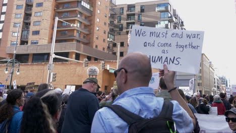 Anti-war-Protester-holding-sign-during-a-rally-in-downtown-Denver-Colorado