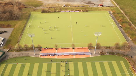 A-bird's-eye-view-of-a-drone-camera-performing-a-hyper-lapse,-circling-two-games-going-on-at-once