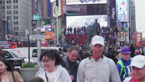A-crowd-of-people-walking-around-Times-Square-in-Manhattan,-New-York